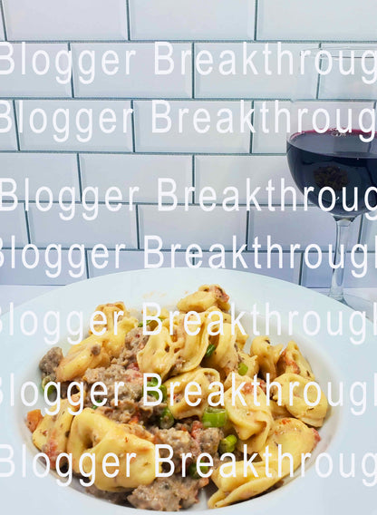A plate of pasta with a glass of wine and the words Blogger Breakthrough Summit.